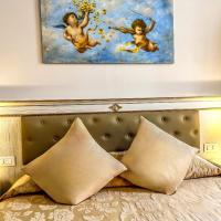 a bedroom with a bed with a painting on the wall at Hotel Genova Liberty in Genoa