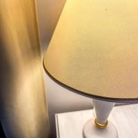 a lamp with a beige lamp shade on a table at Hotel Genova Liberty in Genoa