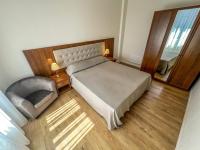 a bedroom with a bed and a chair and a window at Hotel Genova Liberty in Genoa