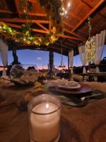 a candle on a table with a view of the ocean at Pousada Villa Dolce Amore - Boutique Hotel in Campos do Jordão