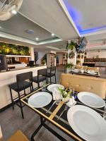 a restaurant with tables and chairs and a counter at Candy Beach Seaview Jomtien in Jomtien Beach