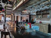 a bar in a restaurant with glasses on the ceiling at Hotel Manantay Resort in Pucallpa