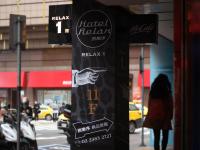 a black sign on the side of a street at Hotel Relax I in Taipei