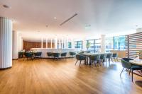 a dining room with tables and chairs and windows at HABAKUK Wellness & Event Hotel in Maribor