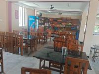 a restaurant with tables and chairs in a room at Aryas Residency- Near Isha Foundation Coimbatore & Karunya University in Alāndurai
