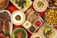 a table topped with plates of different types of food at Carlton Al Moaibed Hotel in Dammam