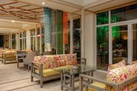 a patio with couches and a table and chairs at Carlton Al Moaibed Hotel in Dammam