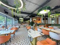 een restaurant met witte tafels en oranje stoelen bij Superior Laguna Beskidow Green! Sauna & Gym! Air Condition! in Zarzecze