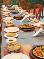 un lungo tavolo con piatti di cibo sopra di Reef House a Marsa Alam