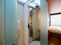 a shower with a glass door in a small bathroom at citizenM New York Times Square in New York
