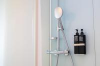 a tripod floor lamp next to a wall at citizenM New York Times Square in New York