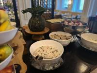a table with bowls of food and a vase at The Gainsborough Bath Spa - Small Luxury Hotels of the World in Bath