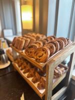a bunch of different types of donuts and pastries on display at The Gainsborough Bath Spa - Small Luxury Hotels of the World in Bath