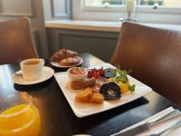 a plate of food and a cup of coffee on a table at The Gainsborough Bath Spa - Small Luxury Hotels of the World in Bath