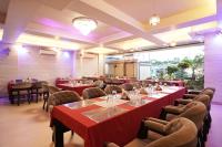 a dining room with red tables and chairs at Hotel JP - 100 meters from the beach in Digha