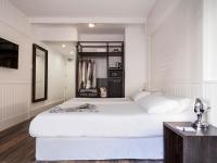 a bedroom with a large white bed and a desk at Delamar 4*Sup-Adults only (18+) in Lloret de Mar