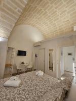 a bedroom with a large bed and a table at La Volta Buona in Matera