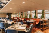 a restaurant with tables and chairs in a room at Boat Hotel Sofia in Ruse