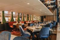 a restaurant with tables and chairs in a room at Boat Hotel Sofia in Ruse