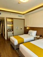 Postel nebo postele na pokoji v ubytování Fortune Plaza Hotel, Dubai Airport