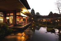 a building with a pond in front of it at Yoshimatsu in Hakone