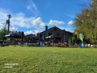 a large building with a grass field in front of it at Les 3 Frères appart calme et reposant en pleine nature in Vresse-sur-Semois