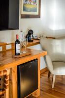 a table with a bottle of wine and glasses on it at Lares De Chacras in Chacras de Coria