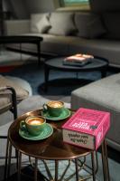 two cups of coffee on a table in a living room at AUHotel -Zayed International Airport-Located in Transit Area -Onwards Boarding Pass Required in Abu Dhabi