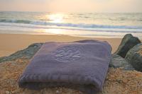 a towel sitting on a rock on the beach at Hotel 202 in Hossegor