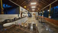 ein großer Raum mit einer Theke mit Töpfen und Pfannen in der Unterkunft Parampara Resort Chikmagalur in Kalasa