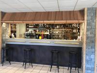 a bar with stools in front of it at Appart Hôtel Le JAS in Ancelle