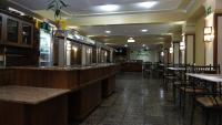 a restaurant with a bar and tables and chairs at Canoas Hotel Castel in Canoas