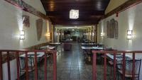 a dining room with tables and chairs in a restaurant at Canoas Hotel Castel in Canoas