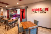 a restaurant with tables and chairs and a sign that reads drinks bar bites at Hampton Inn Pullman in Pullman