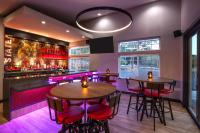 a restaurant with tables and a bar with purple lighting at Hampton Inn Pullman in Pullman