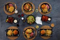 um grupo de pratos de alimentos sobre uma mesa em Gilligan's Hotel & Resort Cairns em Cairns