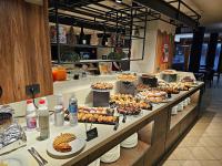 a buffet line with many different types of food at Savoia Resort in Bardonecchia