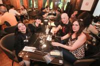 un grupo de personas sentadas en una mesa en un restaurante en Hotel José Nogueira, en Punta Arenas