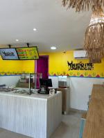 a fast food restaurant with a counter with a computer at Hotel Sun Suite in Barranquilla