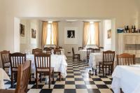 a restaurant with tables and chairs with white table cloth at Cascina Marchesa in Turin