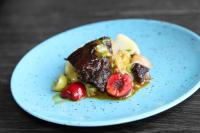 a plate of food with fruit on a table at Sleeping barrel lodge Smaken av Ryfylke Event AS, drives ikke som hotell in Hjelmeland