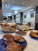a table topped with different types of pastries and bread at Hotel MEDINA in Oran