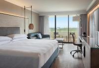 a hotel room with a large bed and a desk at Orlando World Center Marriott in Orlando