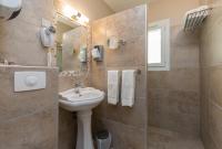 a bathroom with a sink and a mirror at The Originals Boutique, Hôtel du Parc, Cavaillon (Inter-Hotel) in Cavaillon