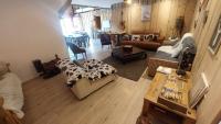 a living room with a couch and a table at Yourtes Olachat proche Annecy in Faverges