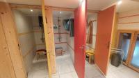 a small bathroom with a red door and a room at Yourtes Olachat proche Annecy in Faverges
