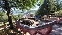 a hammock in a yard with a tree and a house at Yourtes Olachat proche Annecy in Faverges