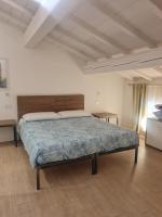 A bed or beds in a room at Carrera Home Appartamenti Verona - Bike Hotel