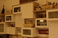 a wall of white cabinets with boxes on them at Hotel Saraceno Resort with Private Beach in Milano Marittima