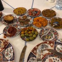 a table with many plates of food on it at Riad Al Fassia Palace in Fès